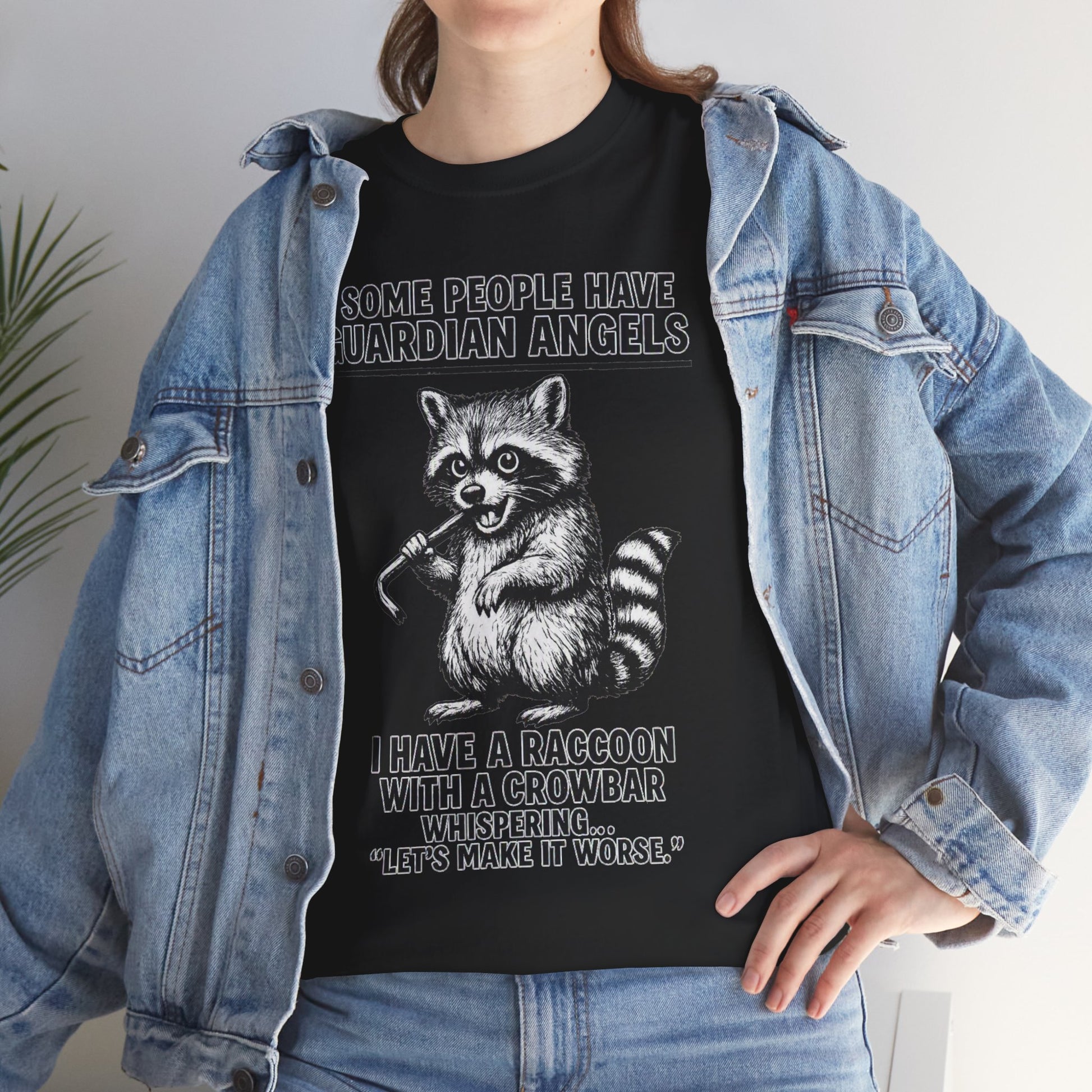 Raccoon wearing a T-shirt with the phrase "Some People Have Guardian Angels" featuring a crowbar, printed by Printify.