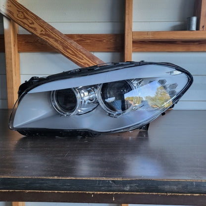 Secondhand Readers Hella Bi-Xenon headlight assembly for 2011-2013 BMW F10 5 Series driver side left headlight.