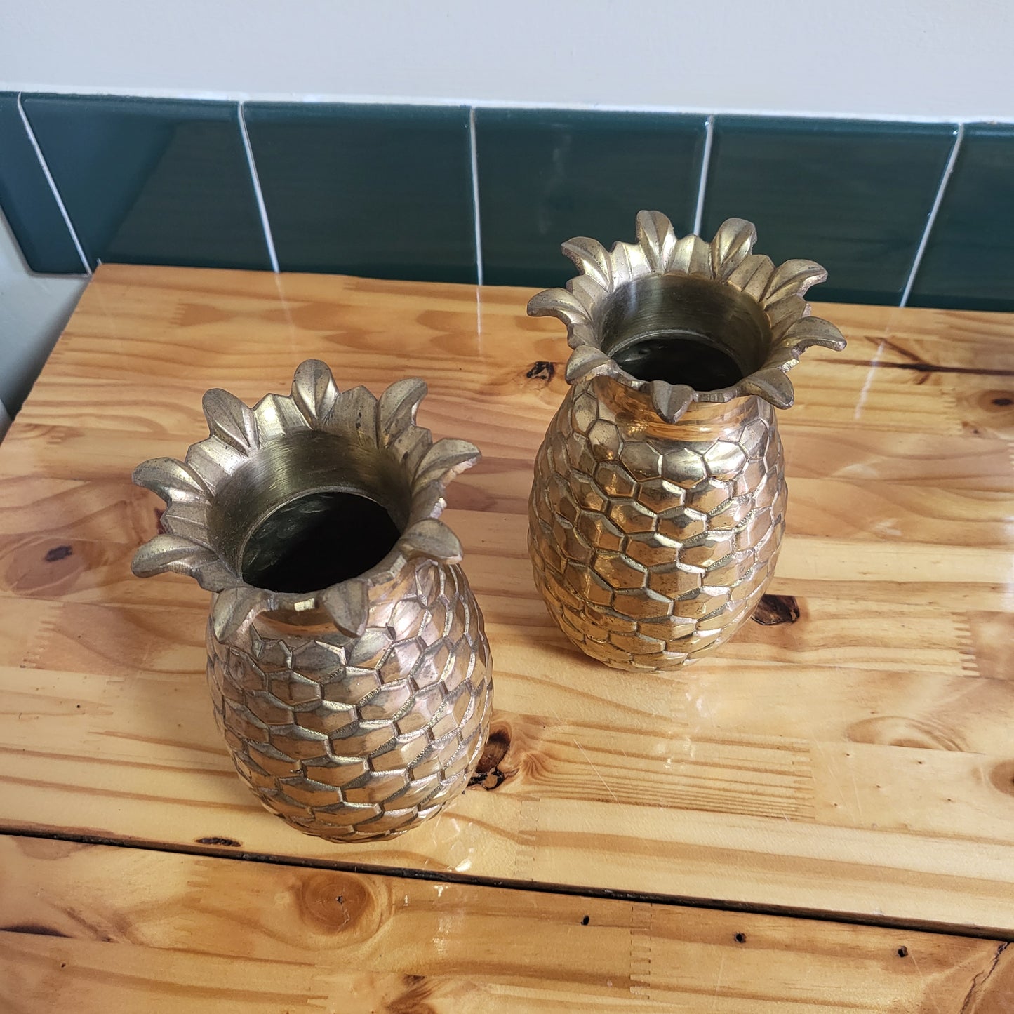 Pair of vintage brass pineapple vases in Hollywood Regency style, 2-piece set with ornate detailing and polished finish.